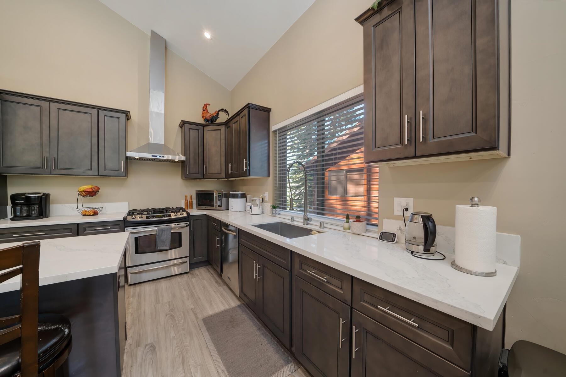 8666 Brook Avenue Kings Beach, CA 96143 - Photo 17 of 21 a kitchen with stainless steel appliances granite countertop a sink stove and cabinets