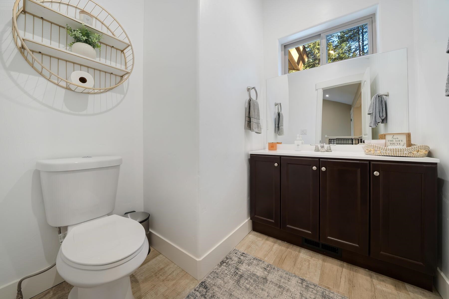 8666 Brook Avenue Kings Beach, CA 96143 - Photo 18 of 21 a bathroom with a toilet sink and mirror