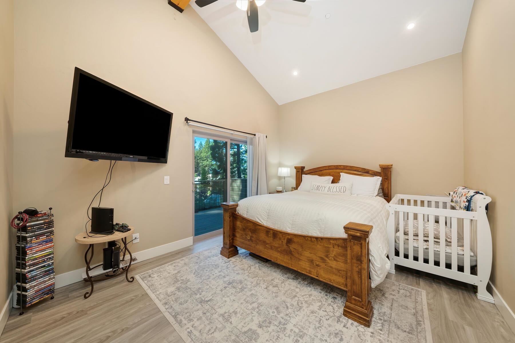 8666 Brook Avenue Kings Beach, CA 96143 - Photo 5 of 21 a bedroom with a bed and wooden floor