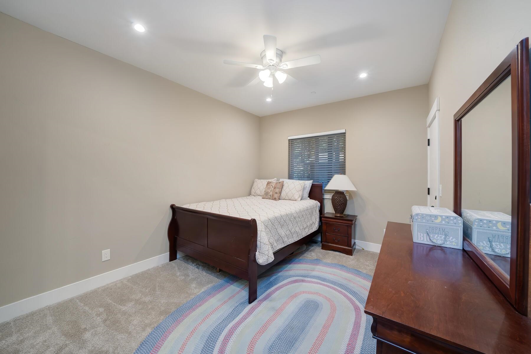 8666 Brook Avenue Kings Beach, CA 96143 - Photo 8 of 21 a spacious bedroom with a bed and a large mirror