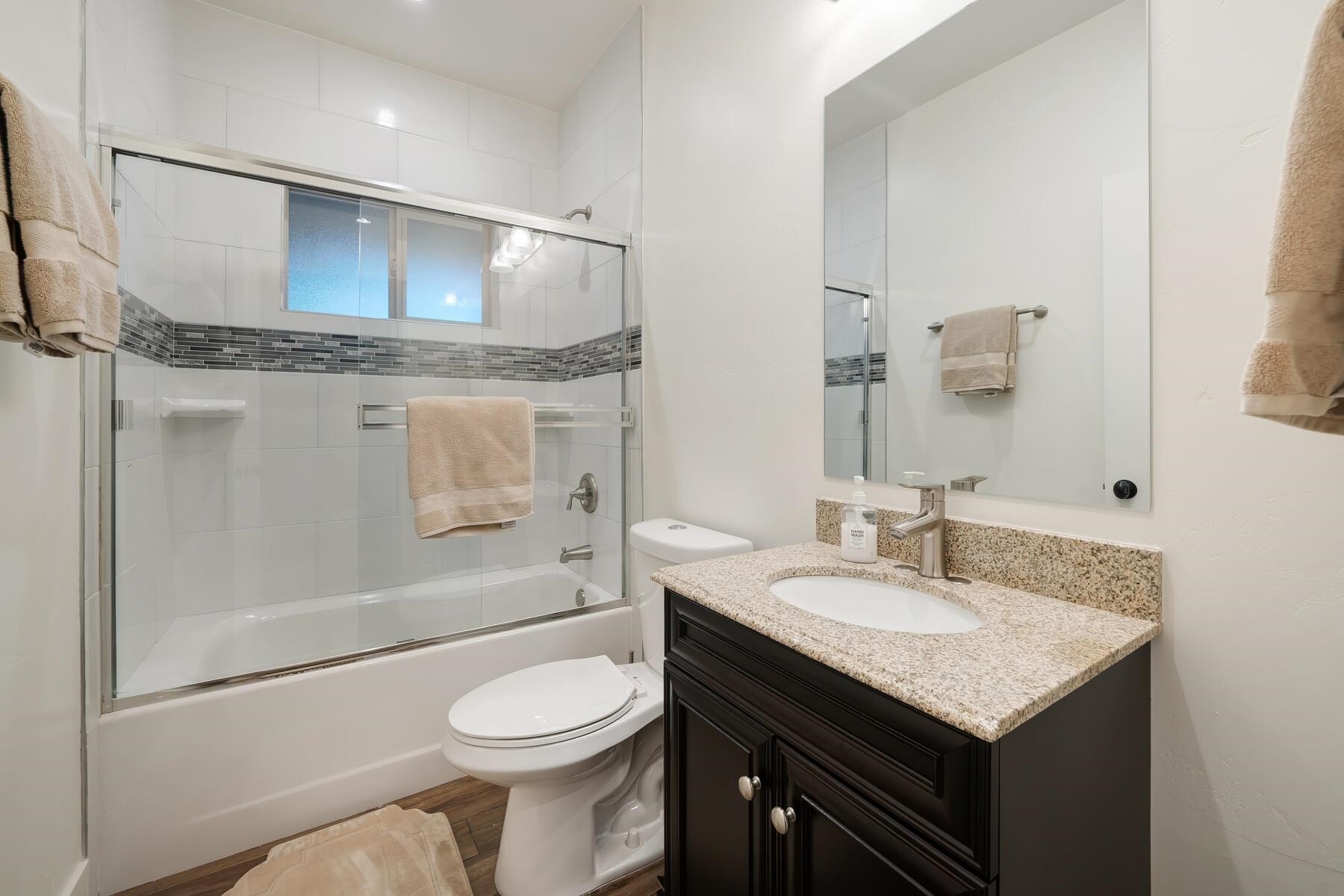 8666 Brook Avenue Kings Beach, CA 96143 - Photo 10 of 21 a bathroom with a granite countertop sink toilet and shower