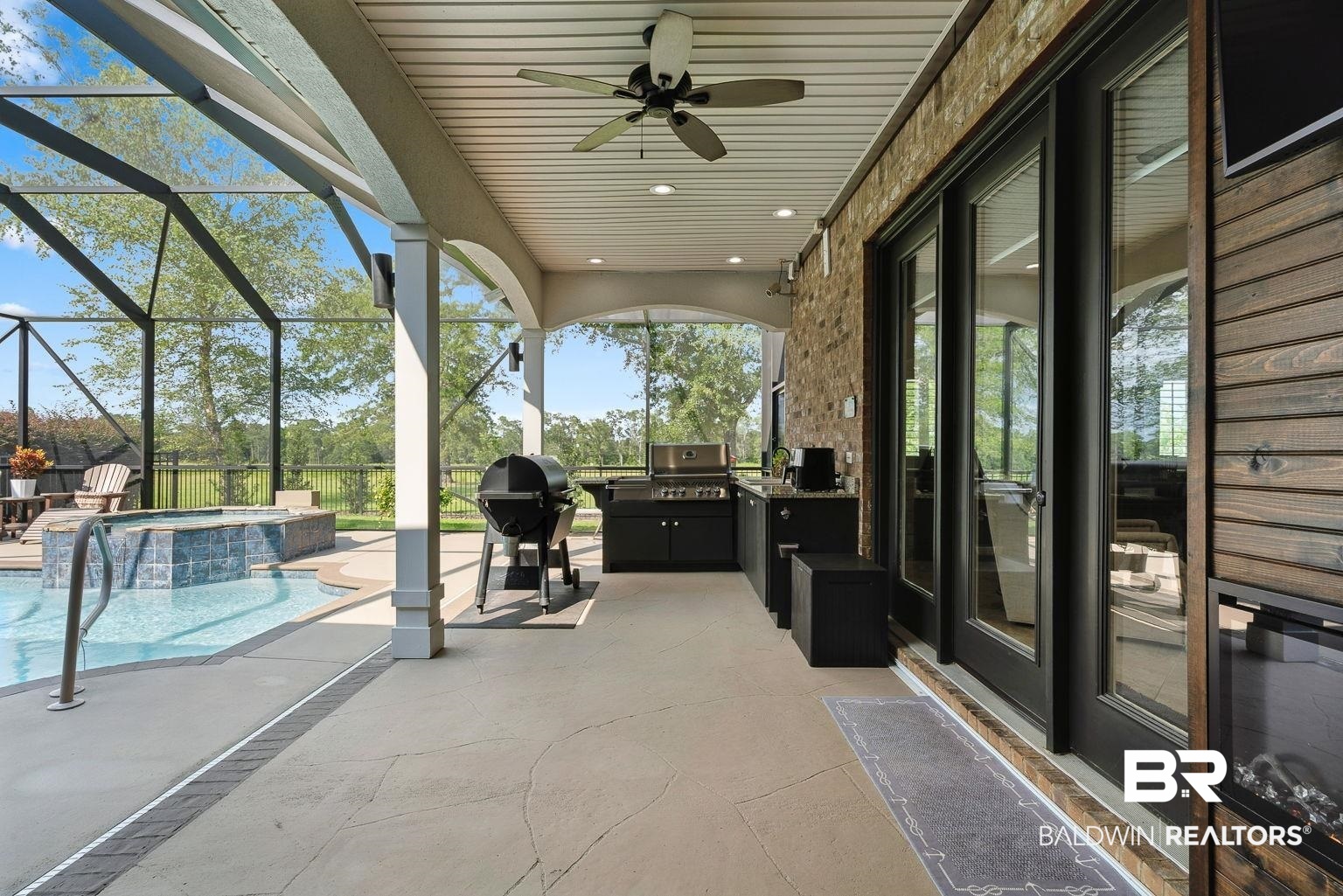 23357 Carnoustie Drive Foley, AL 36535 - Photo 21 of 99 View of patio with glass enclosure, exterior kitchen, ceiling fan, and a pool with connected hot tub