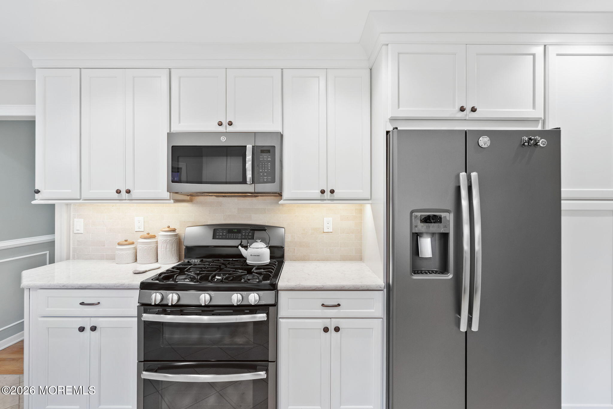 21 Stoney Brook Road Holmdel, NJ 07733 - Photo 7 of 40 a kitchen with stainless steel appliances white cabinets and a stove
