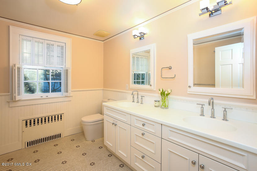34 Spruce Street Riverside, CT 06878 - Photo 17 of 25 a bathroom with a sink a toilet a mirror and a window