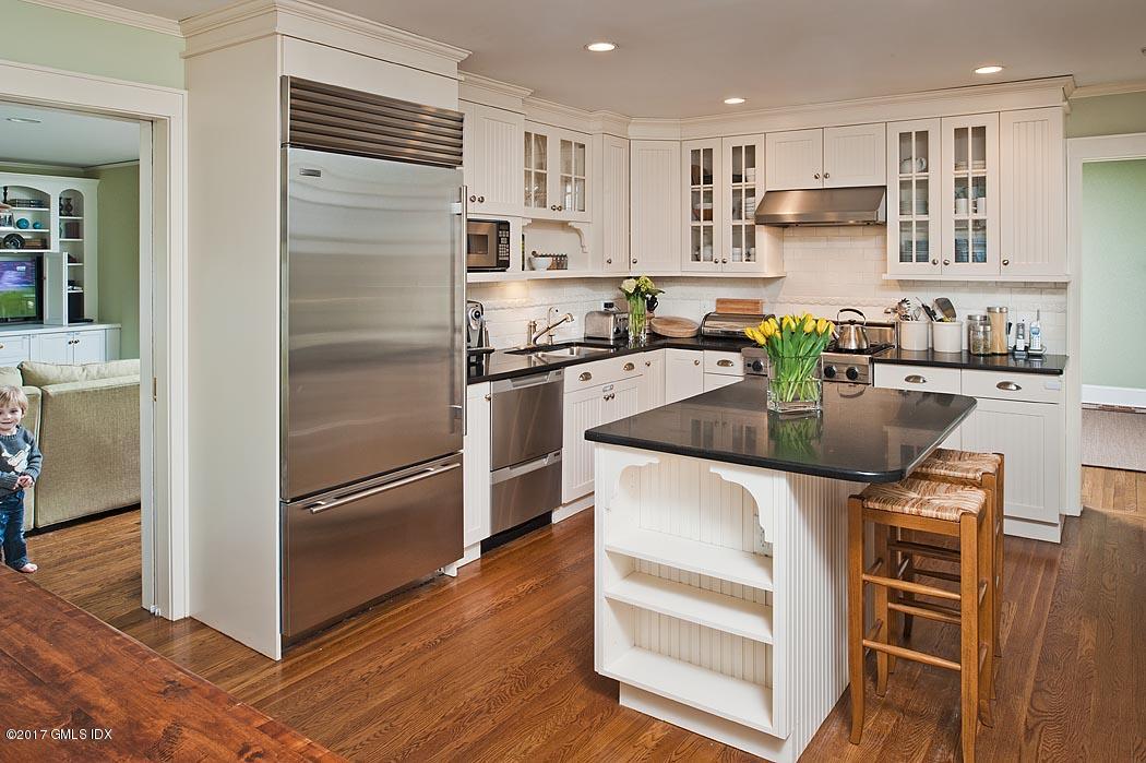 34 Spruce Street Riverside, CT 06878 - Photo 10 of 25 a kitchen with stainless steel appliances granite countertop a refrigerator and a stove top oven