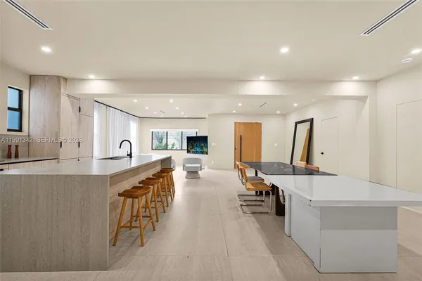 a large white kitchen with a large window