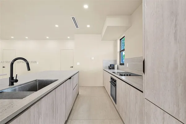 a kitchen with stainless steel appliances granite countertop a sink a stove and a refrigerator