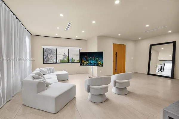 a living room with furniture and a large window