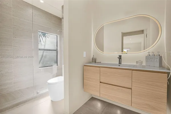 a bathroom with a double vanity sink mirror and shower