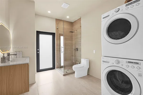 a spacious bathroom with a bathtub sink mirror and toilet