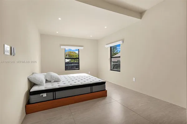 a bedroom with a bed and window