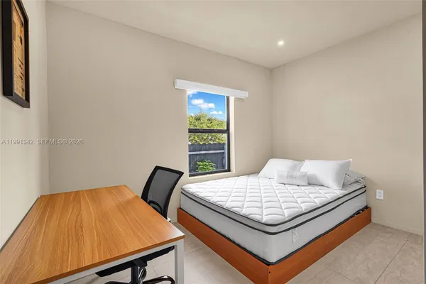 a bedroom with a bed and window