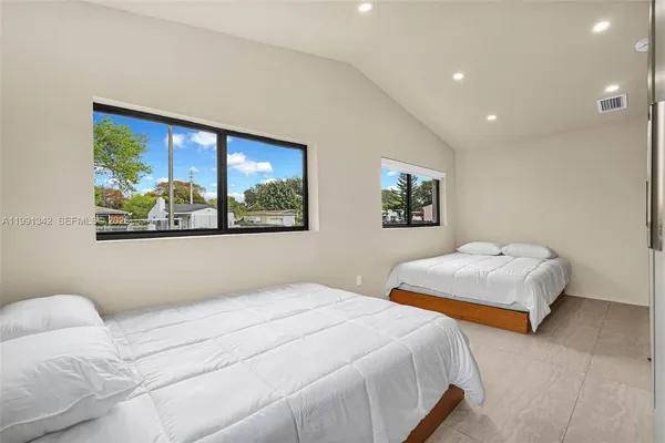 a bedroom with a large bed and a window