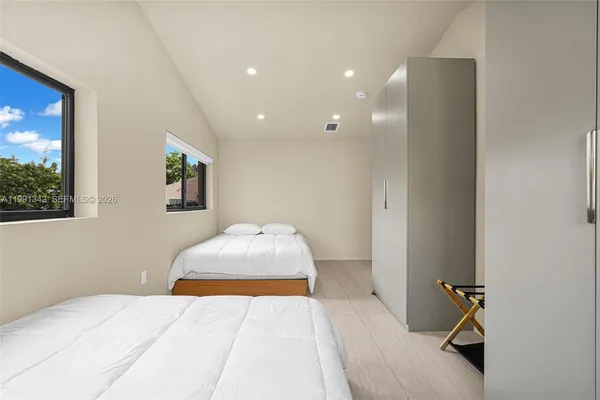 a bedroom with a bed and a painting on the wall