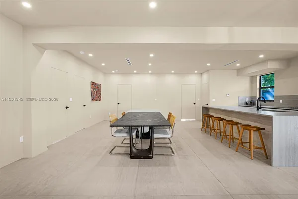 a room with table tennis pool table and chairs