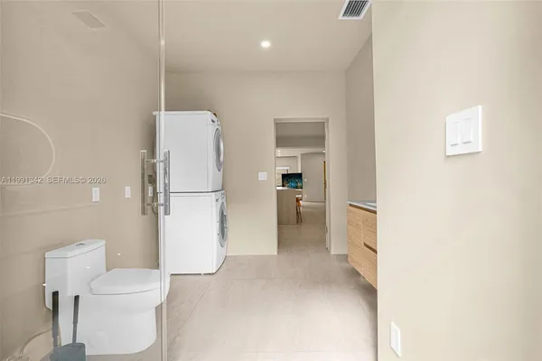 a view of a house with a yard and potted plants
