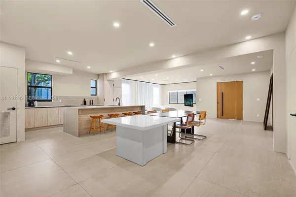 a large kitchen with a table and chairs in it