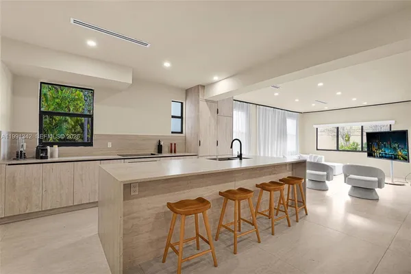 a large kitchen with a table and chairs in it