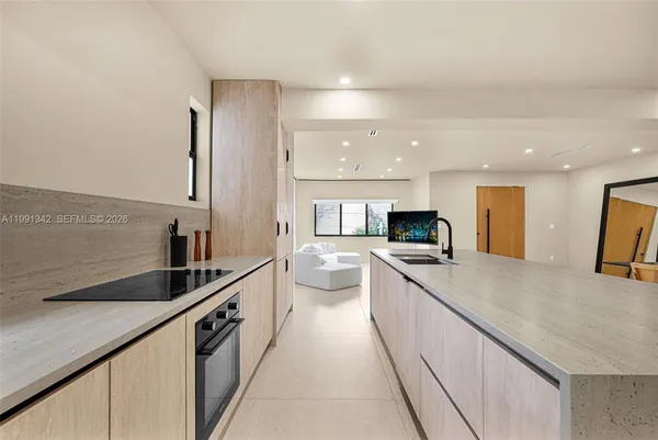 a large kitchen with stainless steel appliances kitchen island a sink and cabinets