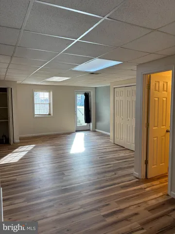 a view of a livingroom with wooden floor and window