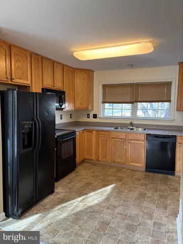 a kitchen with stainless steel appliances granite countertop a stove a sink dishwasher a refrigerator and a microwave oven