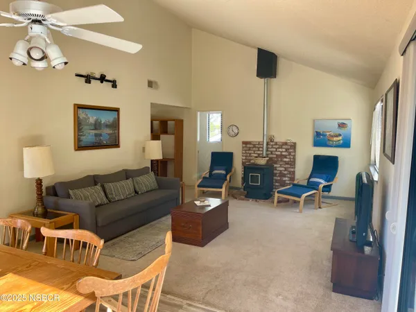 a living room with furniture a computer on desk and chair