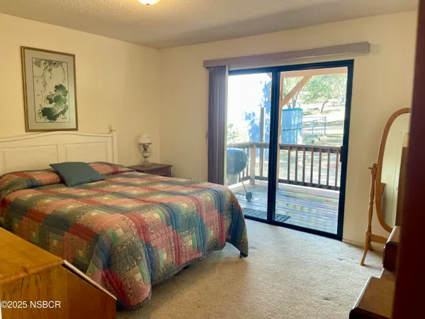 a bedroom with a bed next to a window