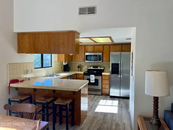 a kitchen with a table chairs and a refrigerator