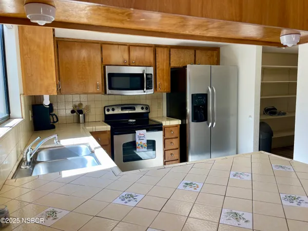 a kitchen with stainless steel appliances a refrigerator and a sink