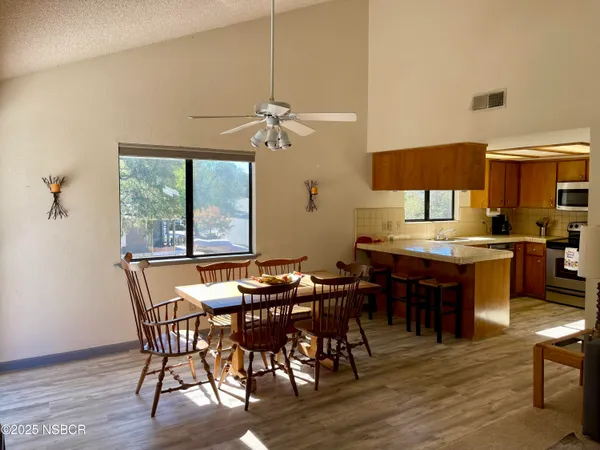 a view of a dining room with furniture window and wooden floor