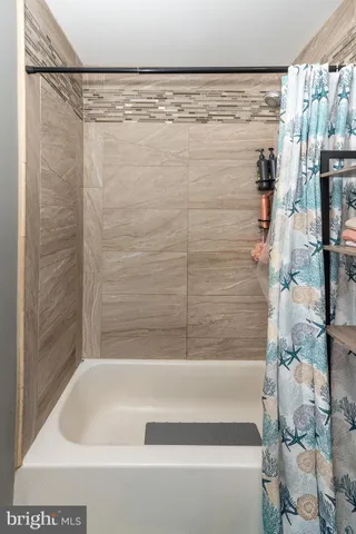 a bathroom with a shower and a bath tub