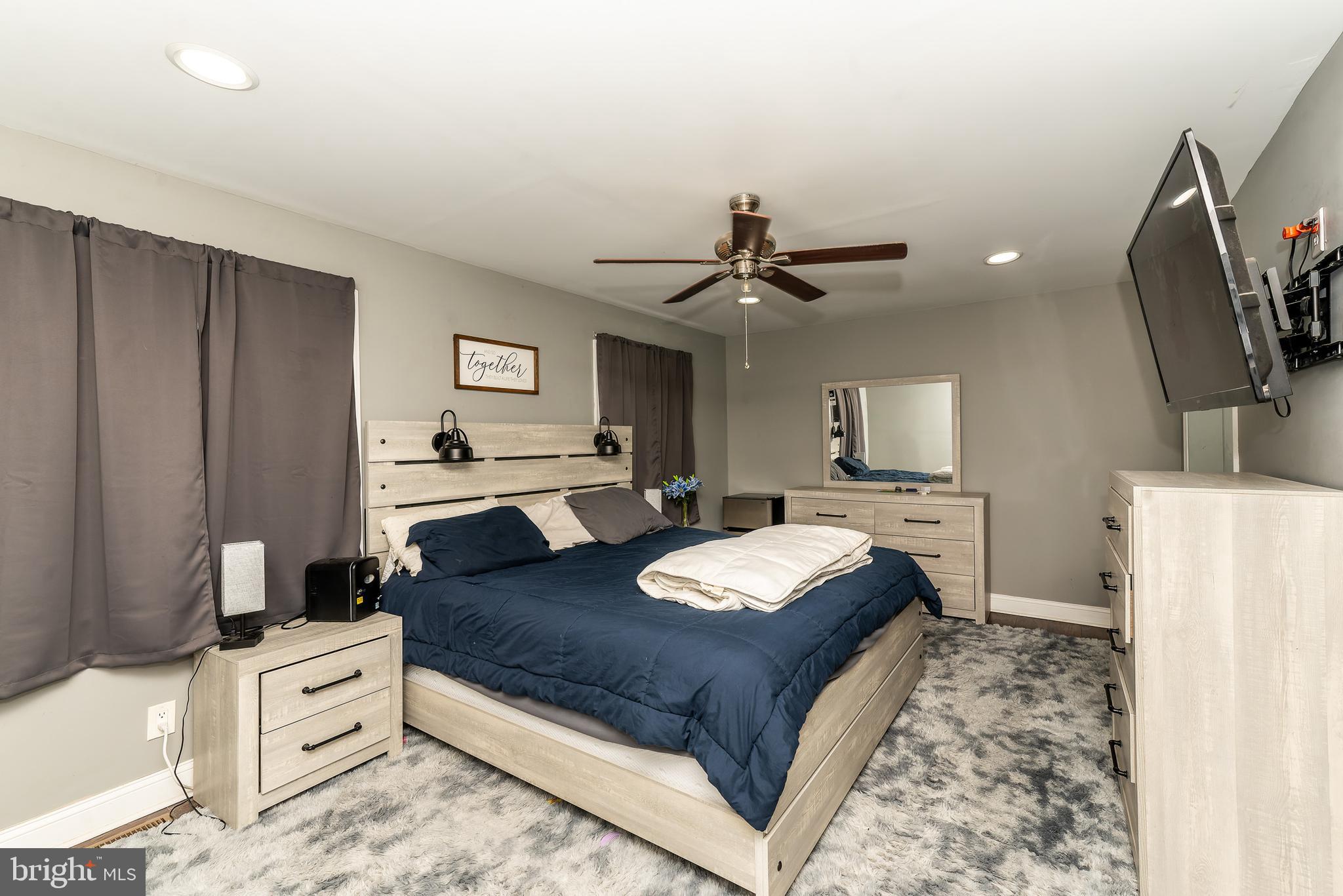 1207 Turnersville Road Pine Hill, NJ 08021 - Photo 14 of 31 a spacious bedroom with a bed and a flat screen tv