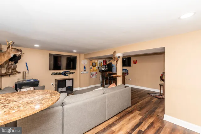 a dining room with furniture and wooden floor