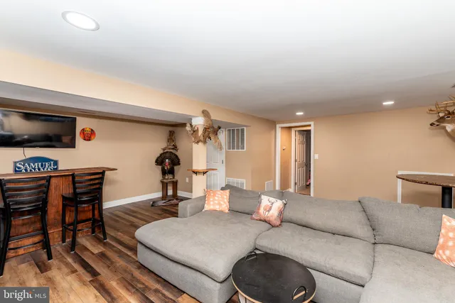 a view of a living room with furniture and a flat screen tv