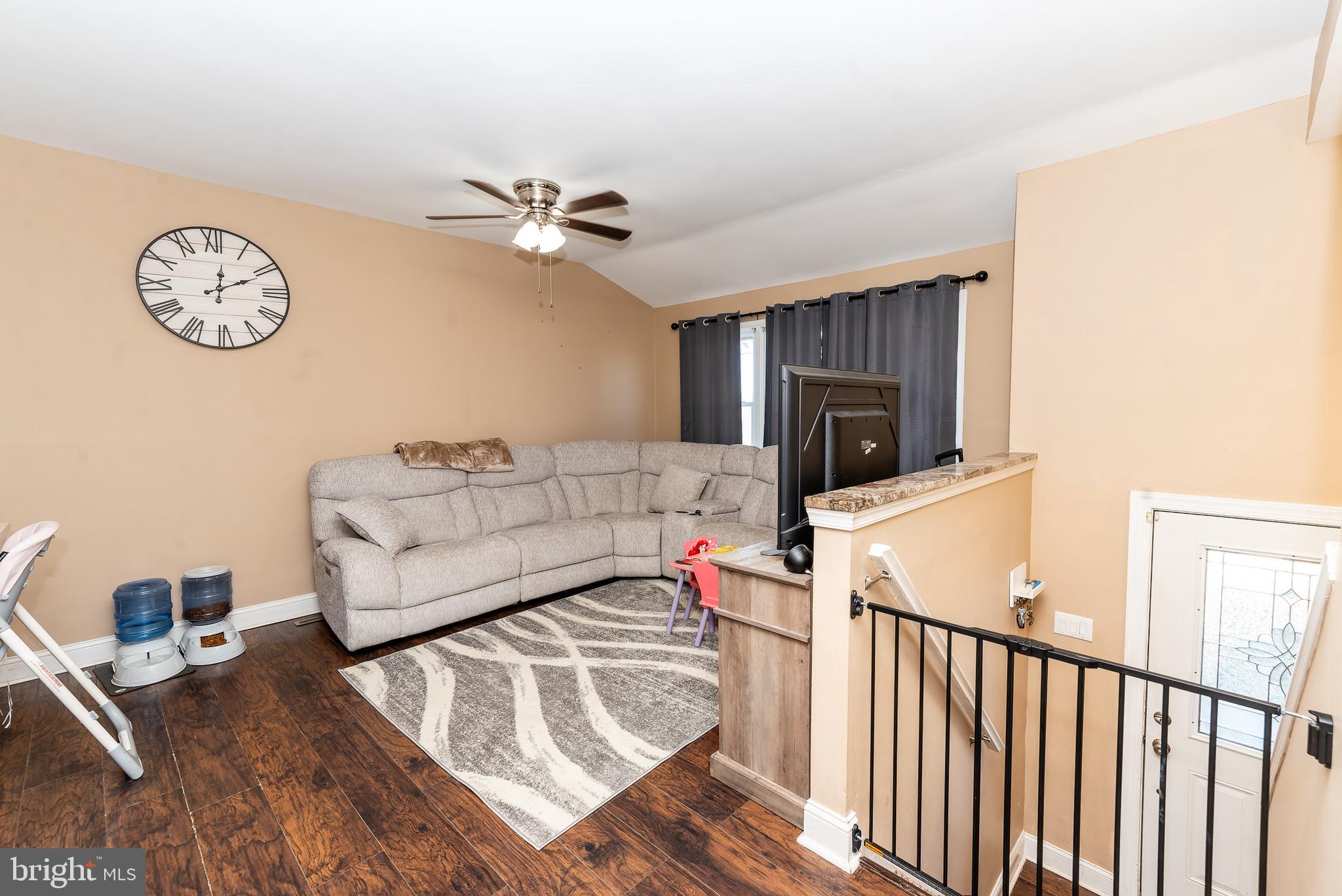 1207 Turnersville Road Pine Hill, NJ 08021 - Photo 5 of 31 a living room with furniture a flat screen tv and a wall clock