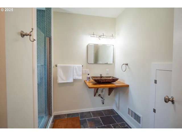 a bathroom with a sink a toilet and a mirror