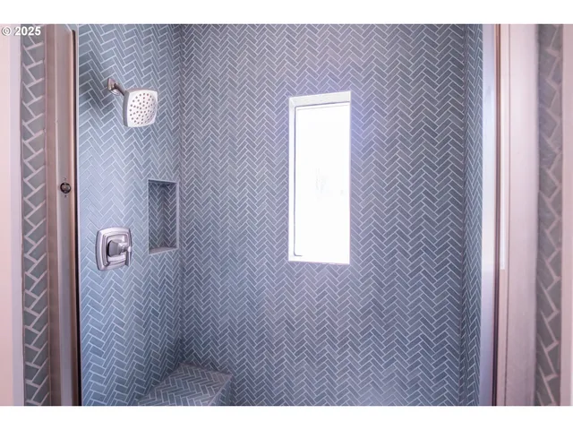 a kitchen with a stove a sink and a window