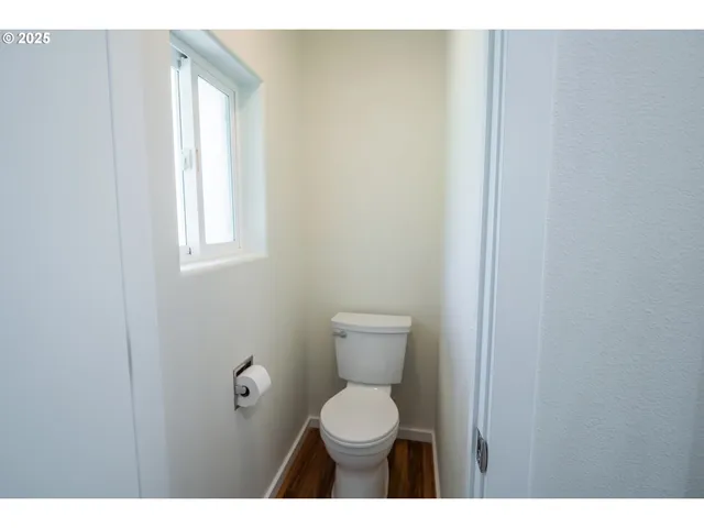 a view of staircase with white walls and a window