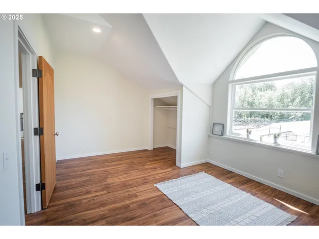 a bathroom with a sink a toilet a mirror and shower