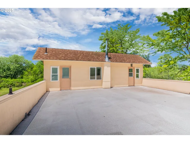 a aerial view of a house with swimming pool and large trees