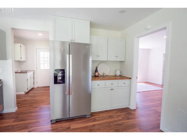 a kitchen with a refrigerator and a sink