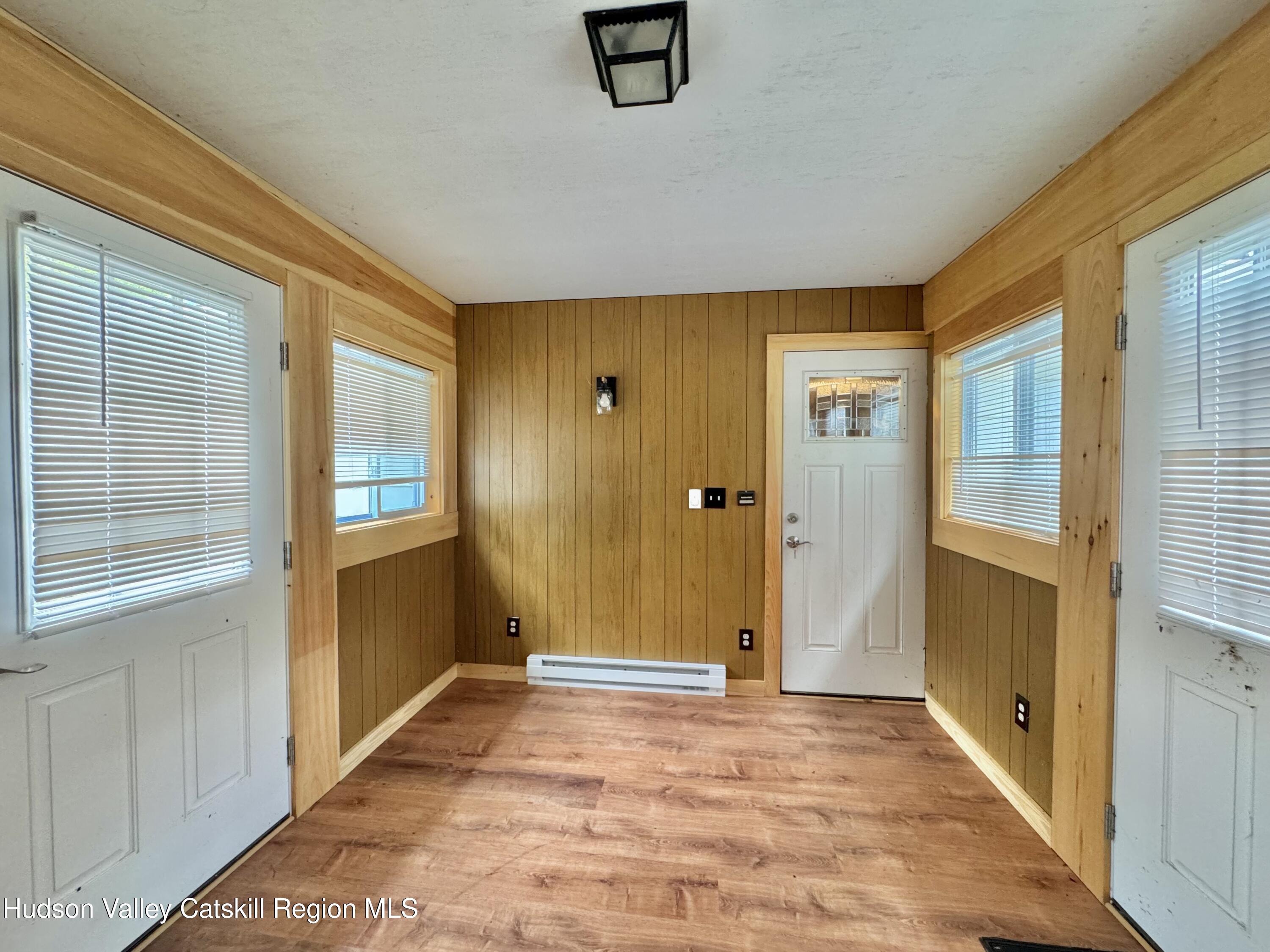 752 Old Rte 23 Acra, NY 12405 - Photo 4 of 25 a view of a hallway with wooden floor and a bathroom