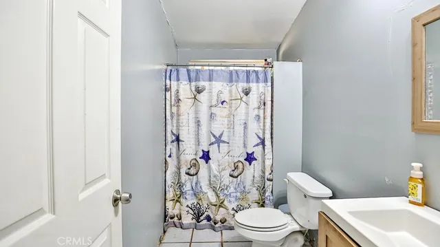a white toilet sitting next to a bathroom sink