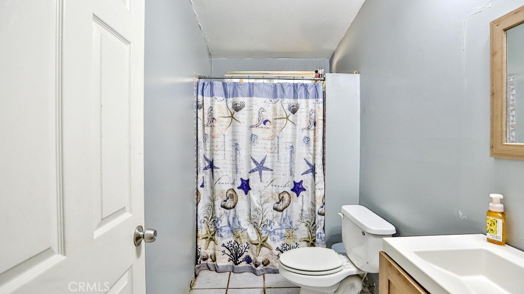 2810 11th Street Riverside, CA 92507 - Photo 12 of 19 a white toilet sitting next to a bathroom sink