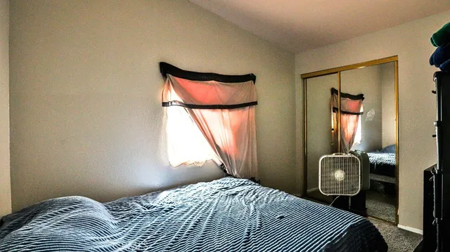 a bedroom with a bed and window