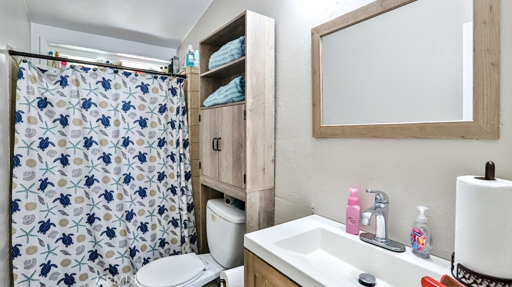 2810 11th Street Riverside, CA 92507 - Photo 14 of 19 a bathroom with a sink toilet and shower