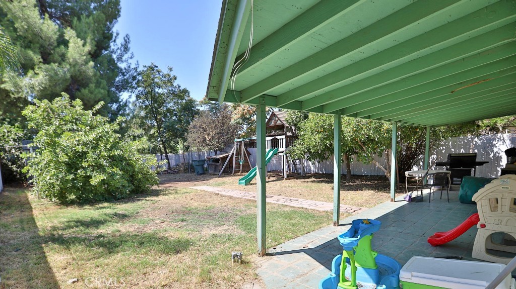 2810 11th Street Riverside, CA 92507 - Photo 15 of 19 a view of a patio with table and chairs under an umbrella