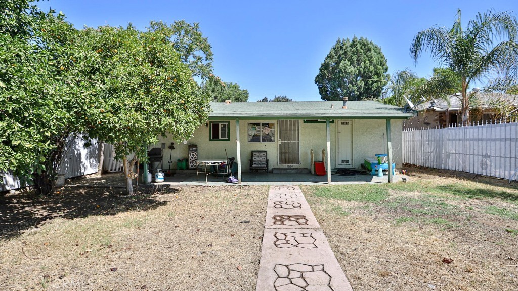 2810 11th Street Riverside, CA 92507 - Photo 18 of 19 a front view of a house with a yard and potted plants