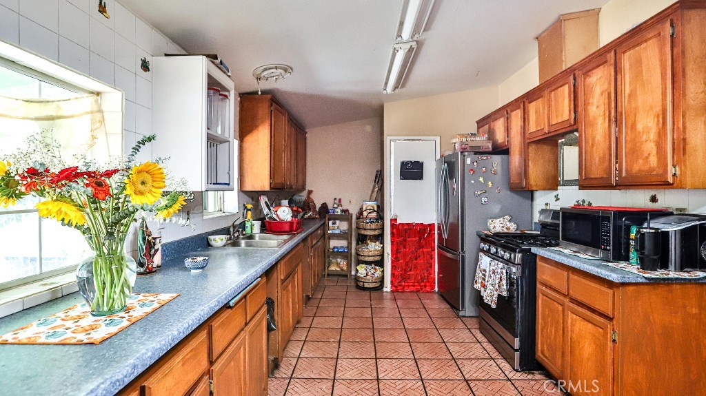 2810 11th Street Riverside, CA 92507 - Photo 7 of 19 a kitchen with stainless steel appliances granite countertop a sink and cabinets