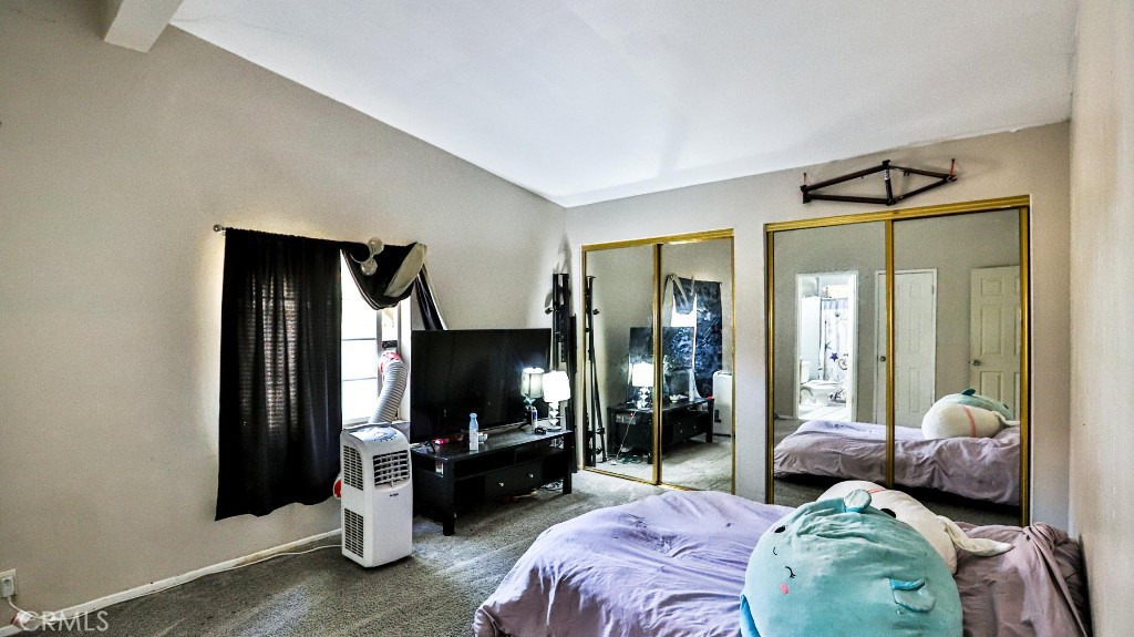 2810 11th Street Riverside, CA 92507 - Photo 9 of 19 a bedroom with a bed and a mirror